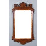 A 19th Century Mahogany Framed Wall Mirror, with shaped cresting and apron, inset with plain