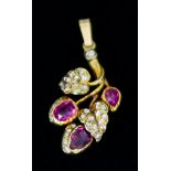 A Yellow Metal Pendant, set with small old cut diamonds and three collet rubies in foliate form,