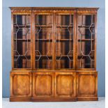 A Mahogany Break Front Bookcase of "Georgian" Design, the upper part with moulded cornice, dentil