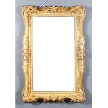 A Late 19th Century Gilt Rectangular Wall Mirror, the ornate frame with trailing leaf, floral and