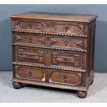 A 17th Century Panelled Oak Chest, with moulded edge to top, fitted four long drawers with geometric