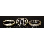 Three White Gold Rings, comprising - a 9ct wedding band, size Q, an 18ct half eternity, size Q,