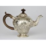 An 18th Century Silver Teapot, hallmarks partially struck, possibly London 1767, the domed cover and