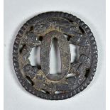 A Japanese Iron Tsuba, Hizen School, Naga Maru-gata depicting dragon, clouds and waves, Edo