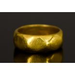 A Yellow Metal Wedding Band, with Oriental script to inside, size O, gross weight 9.4g Note: Metal
