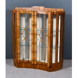 A 20th Century Figured Walnut Display Cabinet of "Art Deco" Design, fitted three glass shelves