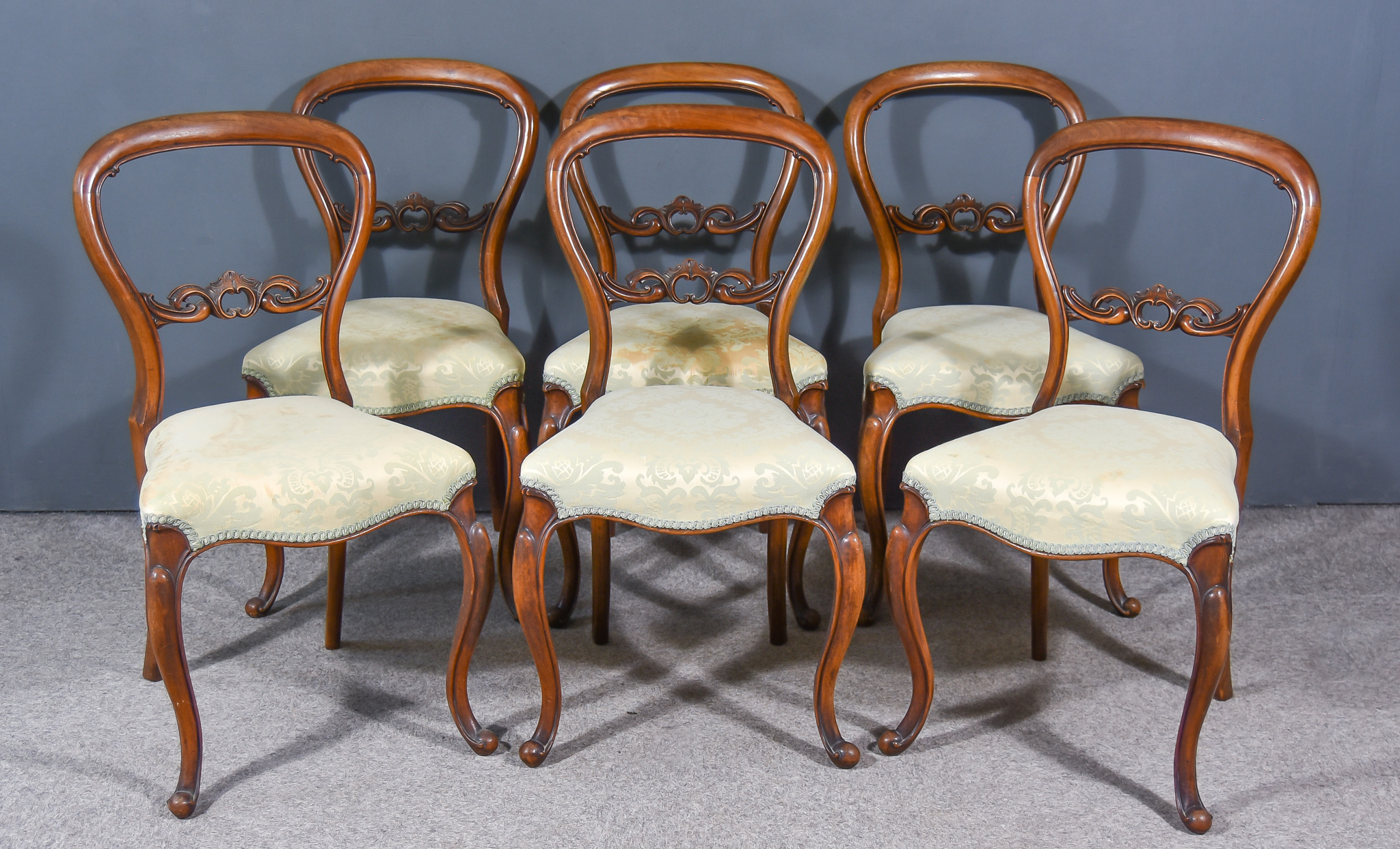 A Set of Six Victorian Mahogany Balloon Back Dining Chairs, with moulded frames, fretted and