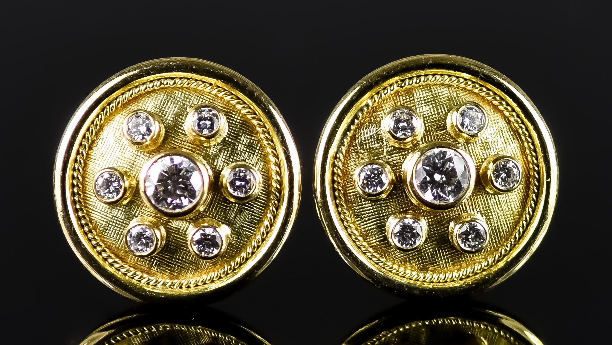 A Pair of 18ct Gold and Diamond Earrings, 20th Century, for pierced ears, each 20mm diameter, set