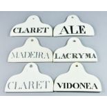 Six 19th Century Ceramic Bin Labels, of coathanger form,worded in black 'ALE', 'LACRYMA', 'VIDONEA',