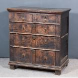 A 17th Century Panelled Oak Chest, with moulded edge to top, fitted two short and three long