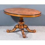 A Victorian Walnut and Ebonised Oval Breakfast Table, the quarter veneered top inlaid with birds eye