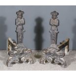 A Pair of Cast Iron Andirons, with figurative fronts on scroll supports, 24ins high