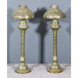 A Pair of Near-Eastern Brass Embossed Table Oil Lamps, now converted to electric, with knopped and
