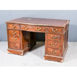 An Early 20th Century Mahogany Kneehole Desk of Serpentine Outline with brown leather cloth inset