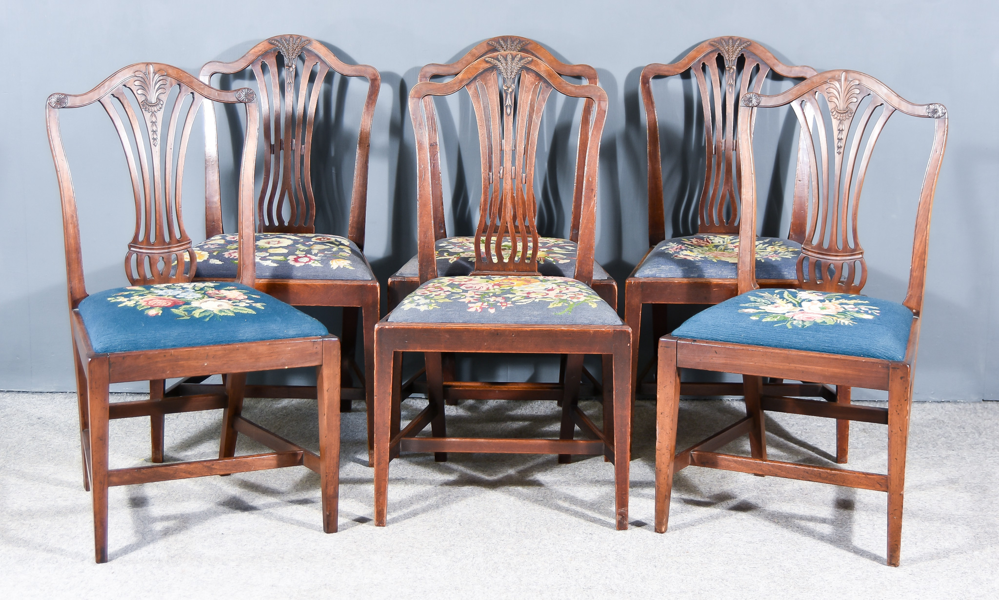 A Harlequin Set of Six Mahogany Dining Chairs of "Hepplewhite" Design, with shaped crest rails,