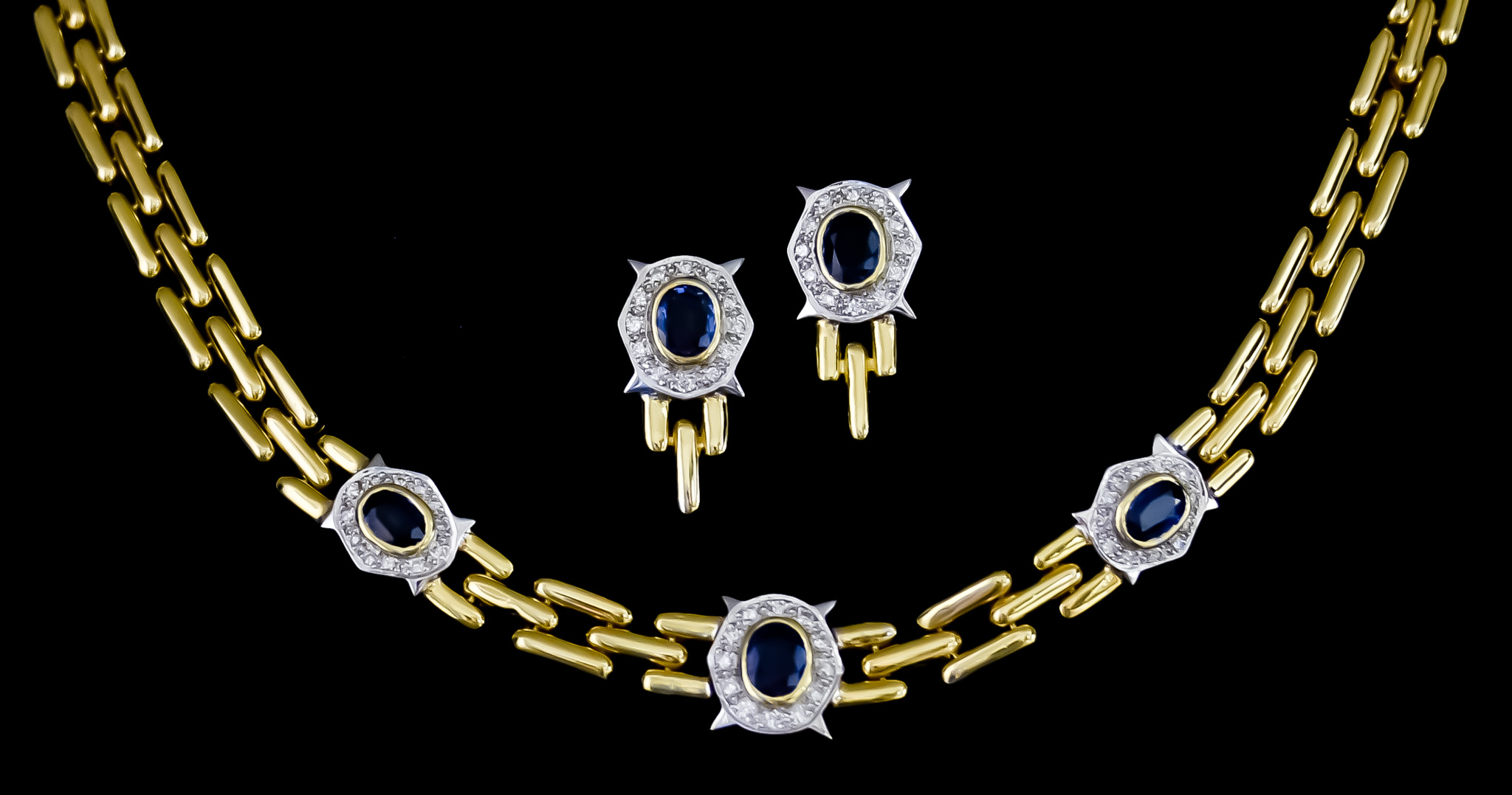 An 18ct Gold Necklace and Earrings Suite, comprising - three row necklace set with brilliant cut