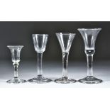 Four Wine Glasses, 18th Century, comprising - bell-shaped bowl over plain stem, on domed folded