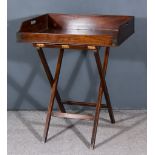 A 19th Century Mahogany Rectangular Butlers Tray, with handle cut-outs and folding stand, 30ins x