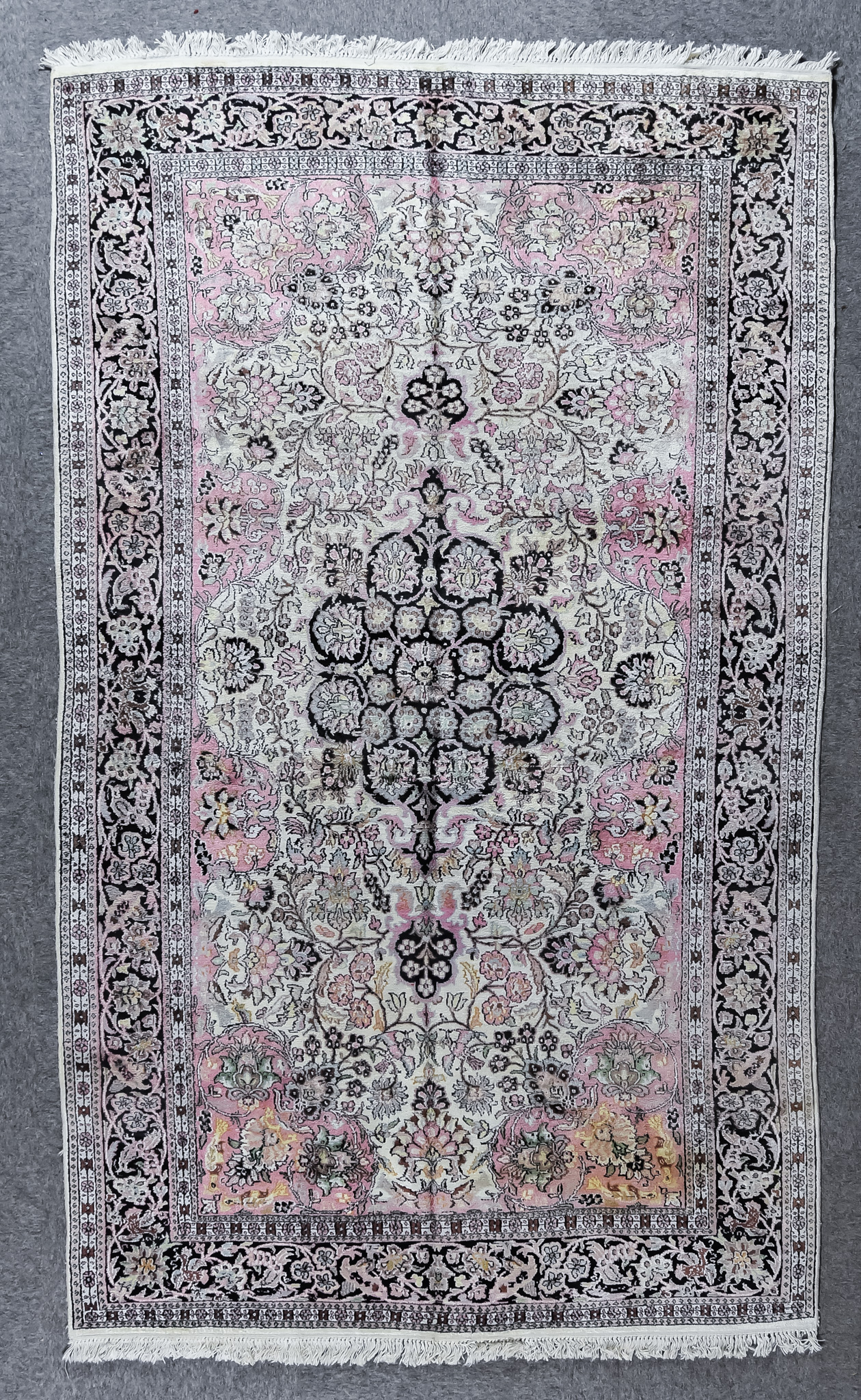 A 20th Century Pure Silk Tabriz Carpet, woven in pastel shades with a bold central floral medallion,