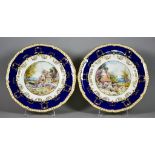 A Pair of Royal Crown Derby Porcelain Plates with white, blue and gilt rims, enamelled in colours by