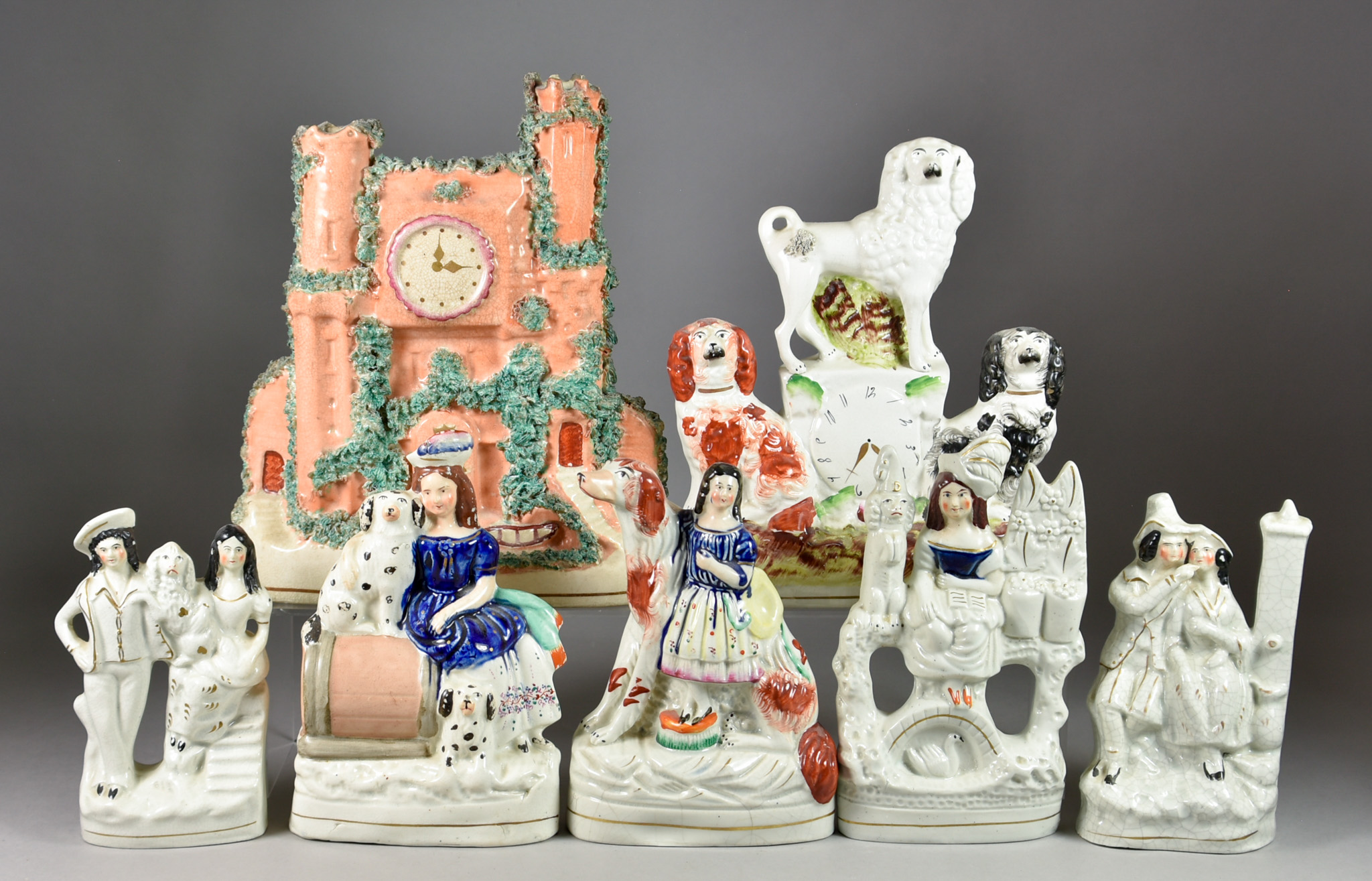 A Staffordshire Pottery Clock Group and Twelve Other Staffordshire Pottery Figures, 19th Century,