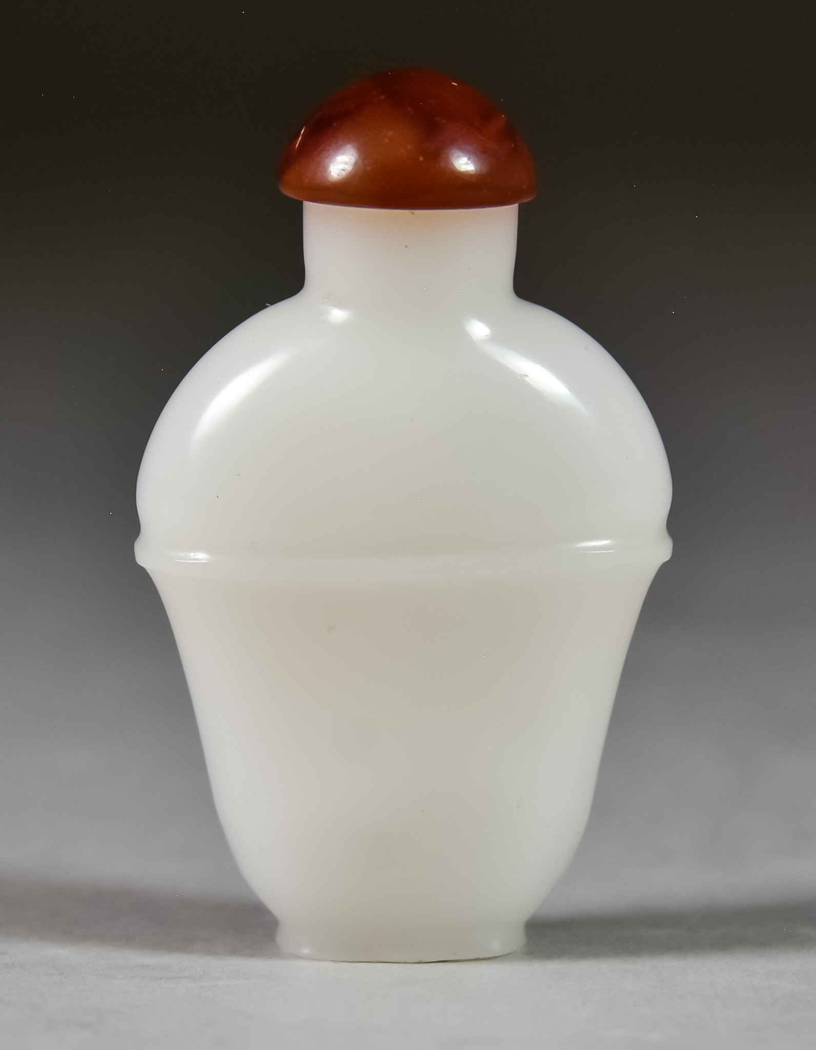 A Chinese White Glass Snuff Bottle, Late 18th/First Half 19th Century, of baluster shape, carved