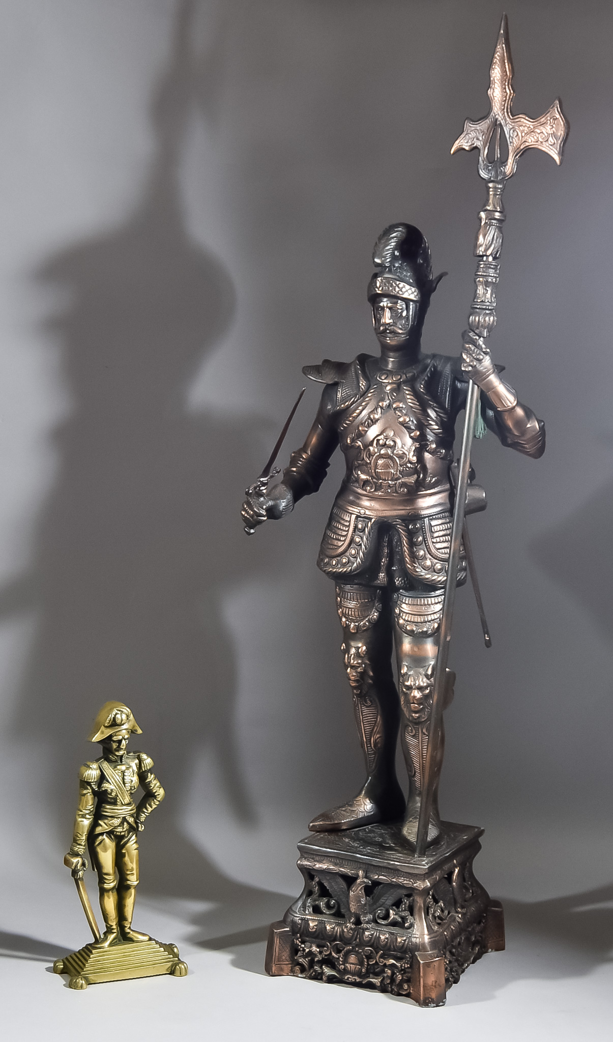 A Bronzed Metal Figure of a Standing Soldier, 20th Century, wearing full armour and holding a