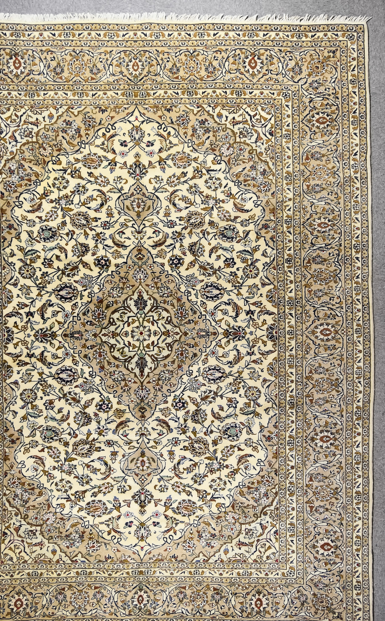 A 20th Century Tabriz Carpet, woven in pastel shades, with a bold central stylised floral