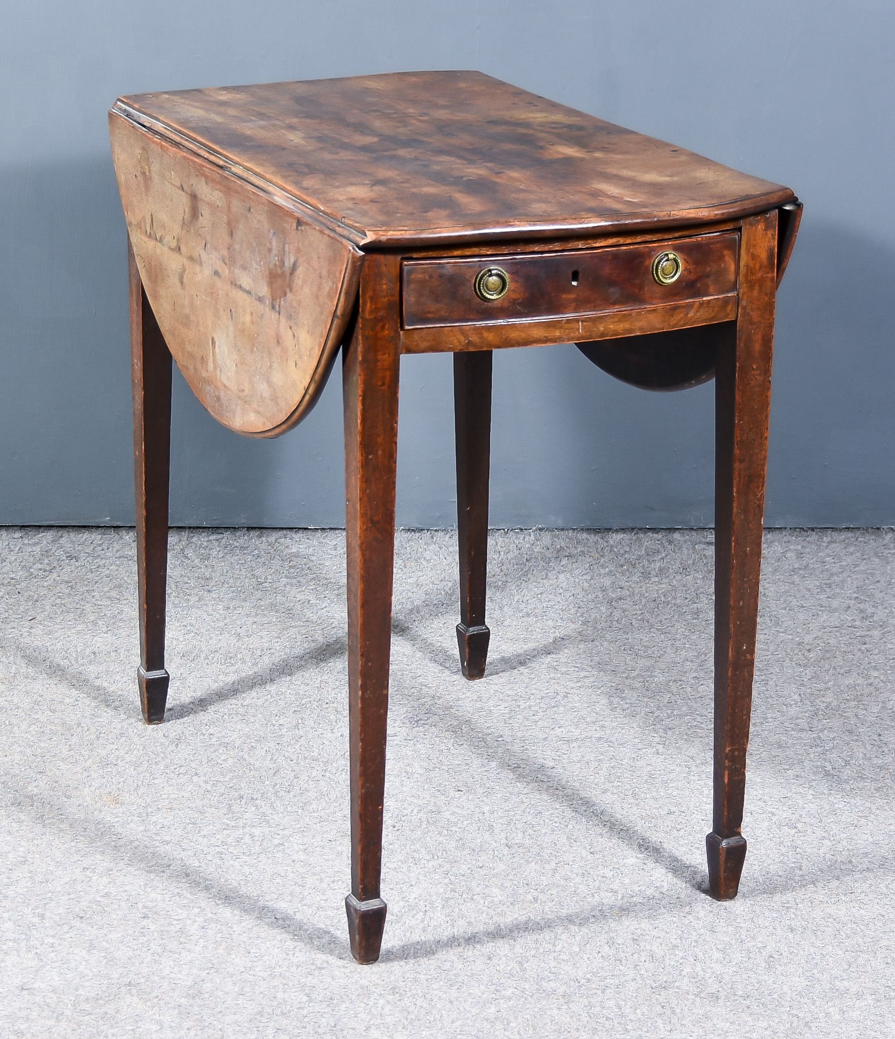 A George III Mahogany Oval Pembroke Table, with moulded edge to top, fitted one real and one dummy