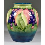 A Moorcroft Pottery Wide Baluster-Shaped Vase, tube-lined and decorated in colours with 'Grape and