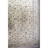 A 20th Century Kashan Carpet, woven in pastel shades, the field filled with trailing leaf and floral