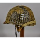 A WWII US Airborne Engineers Helmet, with liner and scrim, (painted), marked with E to side. leather