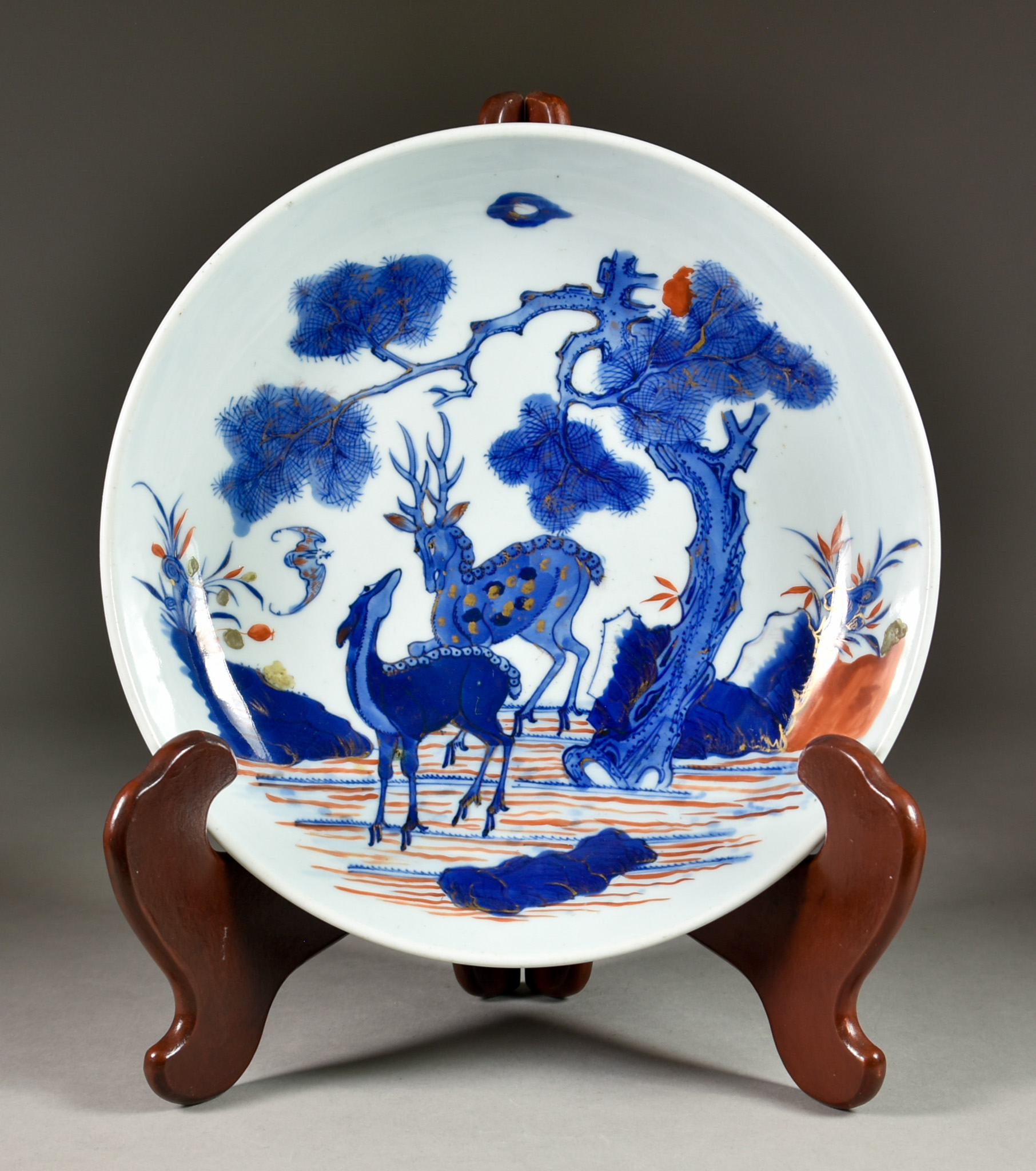 A Chinese Porcelain Saucer-Shaped Dish, 19th Century, painted in blue, red and gilt with two deer