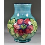 A Moorcroft Pottery Bulbous Vase, tube-lined and decorated in 'Clematis' pattern on a teal ground,
