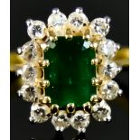 An 18ct Gold Emerald and Diamond Ring, 20th Century, set with a central emerald, approximately .