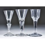 Three Wine Glasses, 18th Century, comprising - drawn trumpet bowl with plain tear-drop stem on a