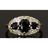 A 9ct Gold Three Stone Sapphire and Diamond Ring, 20th Century, set with three sapphire stones,