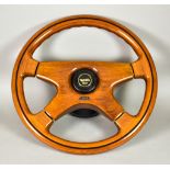 A Hardwood Four Spoke Car Steering Wheel, by O.B.A., 14.5ins diameter, on boss to fit BMW Alpine E30