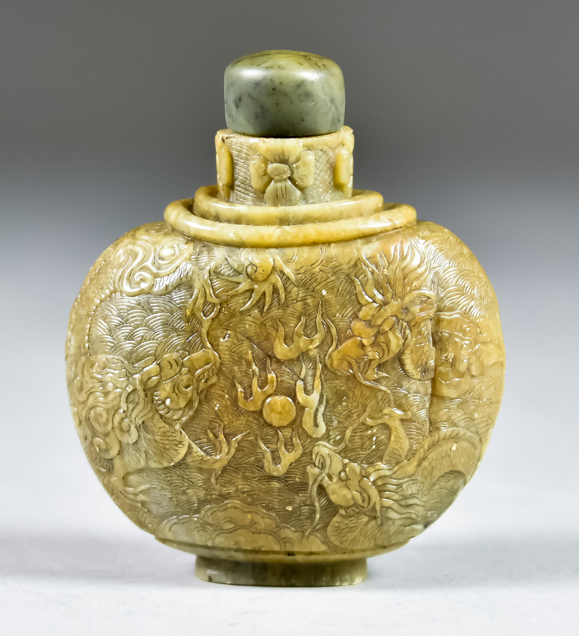 A Chinese Brown Serpentine Snuff Bottle, 19th Century, of wide ovoid form, the neck carved with