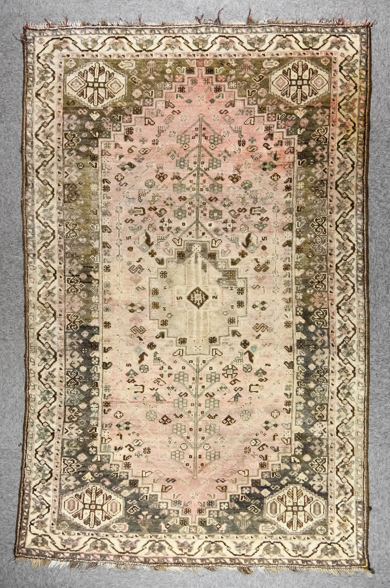 A 20th Century Anatolian Long Rug, woven in muted shades, with a central pole medallion, the field