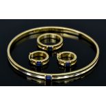 An 18ct Gold and Sapphire Suite, Modern, signed Tiffany & Co., comprising - stiff bangle set with