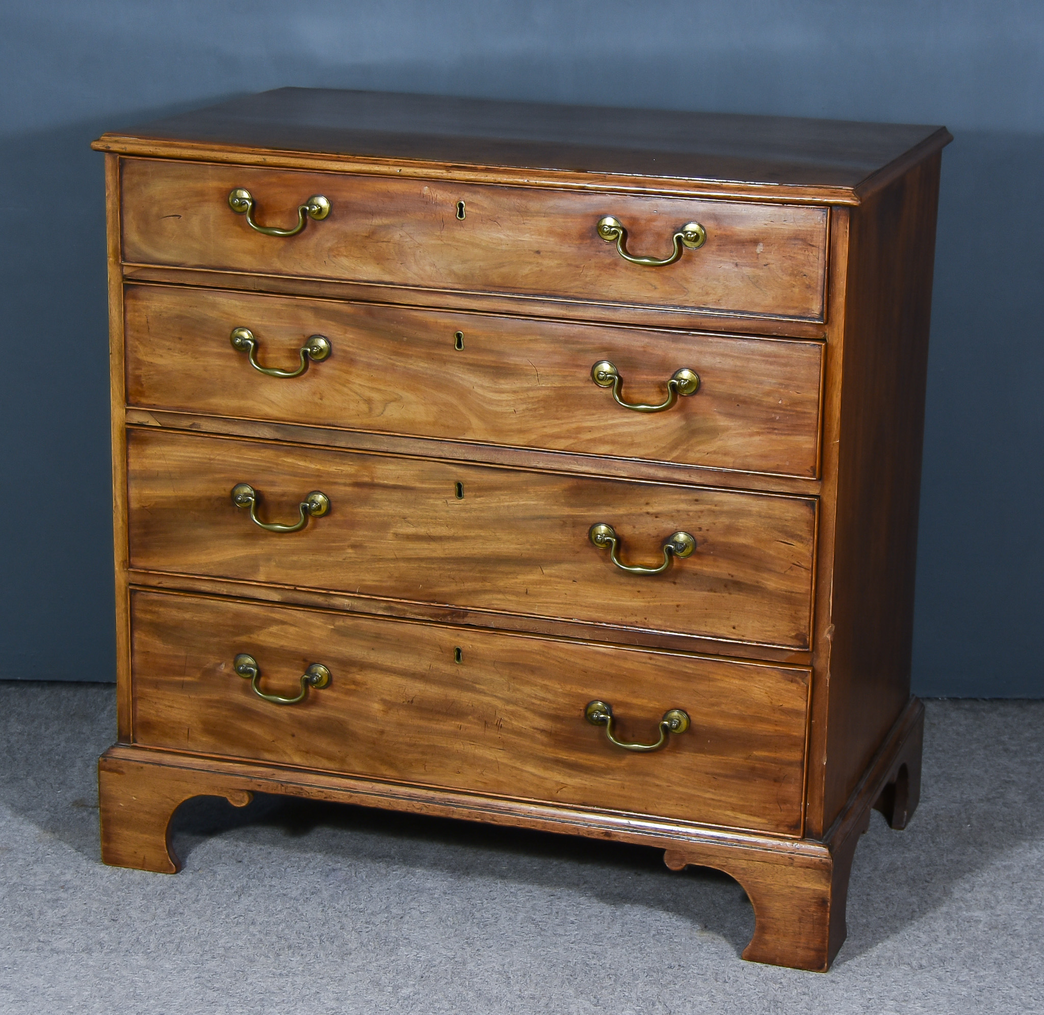 A George III Mahogany Chest, with moulded edge to top, fitted four long graduated drawers, on