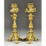 A Pair of Gilt Bronze Candlesticks, Late 19th/Early 20th Century, cast with putto, fawns and