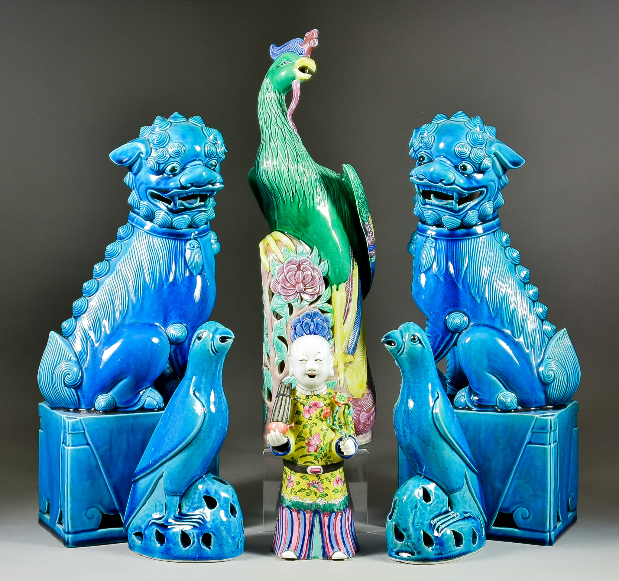 A Chinese Porcelain Standing Figure of a Musician, 19th Century, a bamboo flute in one hand and