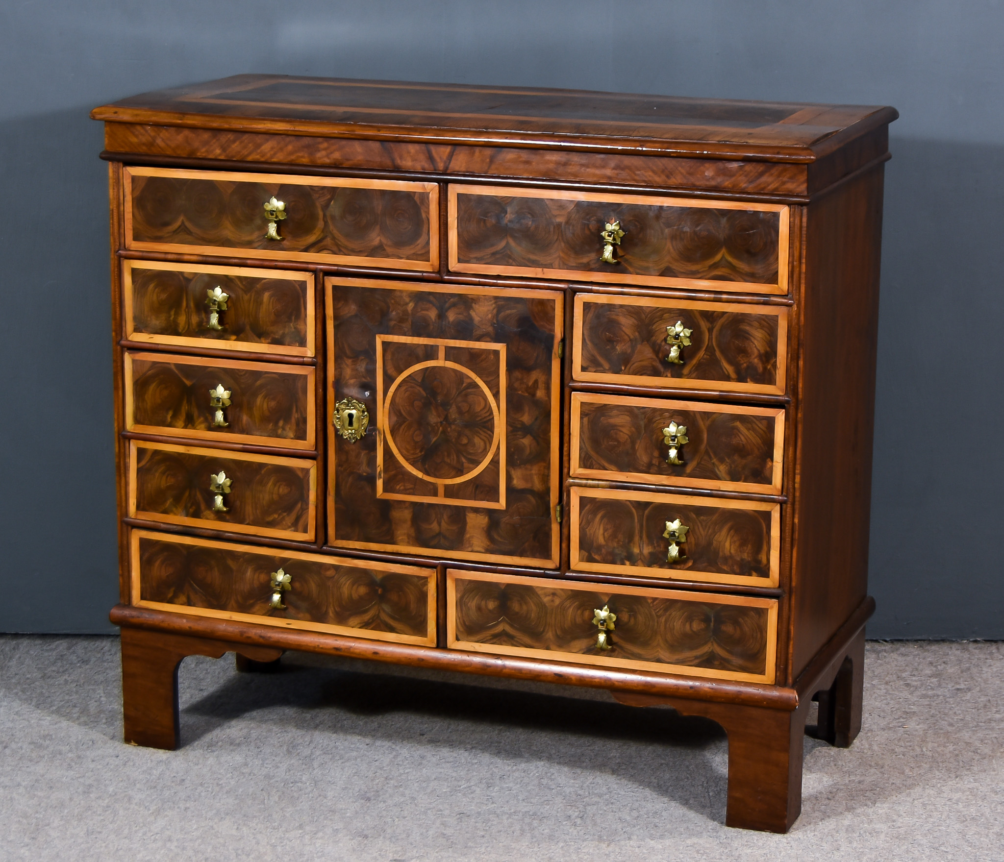 A William and Mary Oysterwood Veneered Chest, the whole inlaid with cross bandings, moulded edge