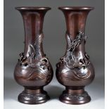 A Pair of Japanese Brown Patinated Bronze Vases of baluster form, cast in relief with dragons on