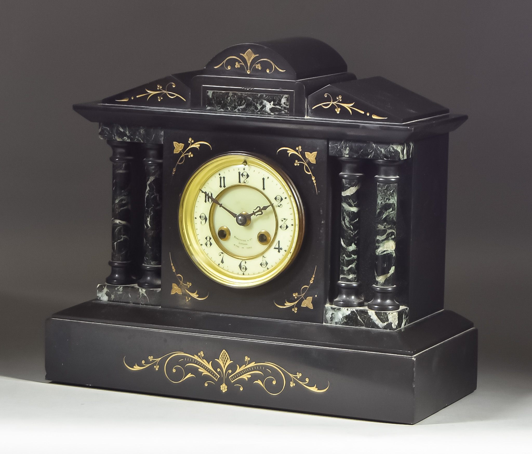 A Late 19th Century French Black Marble and Variegated Marble Cased Mantel Clock retailed by