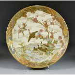 A Japanese Satsuma Circular Dish, Meiji Period, painted with geese taking flight in a river