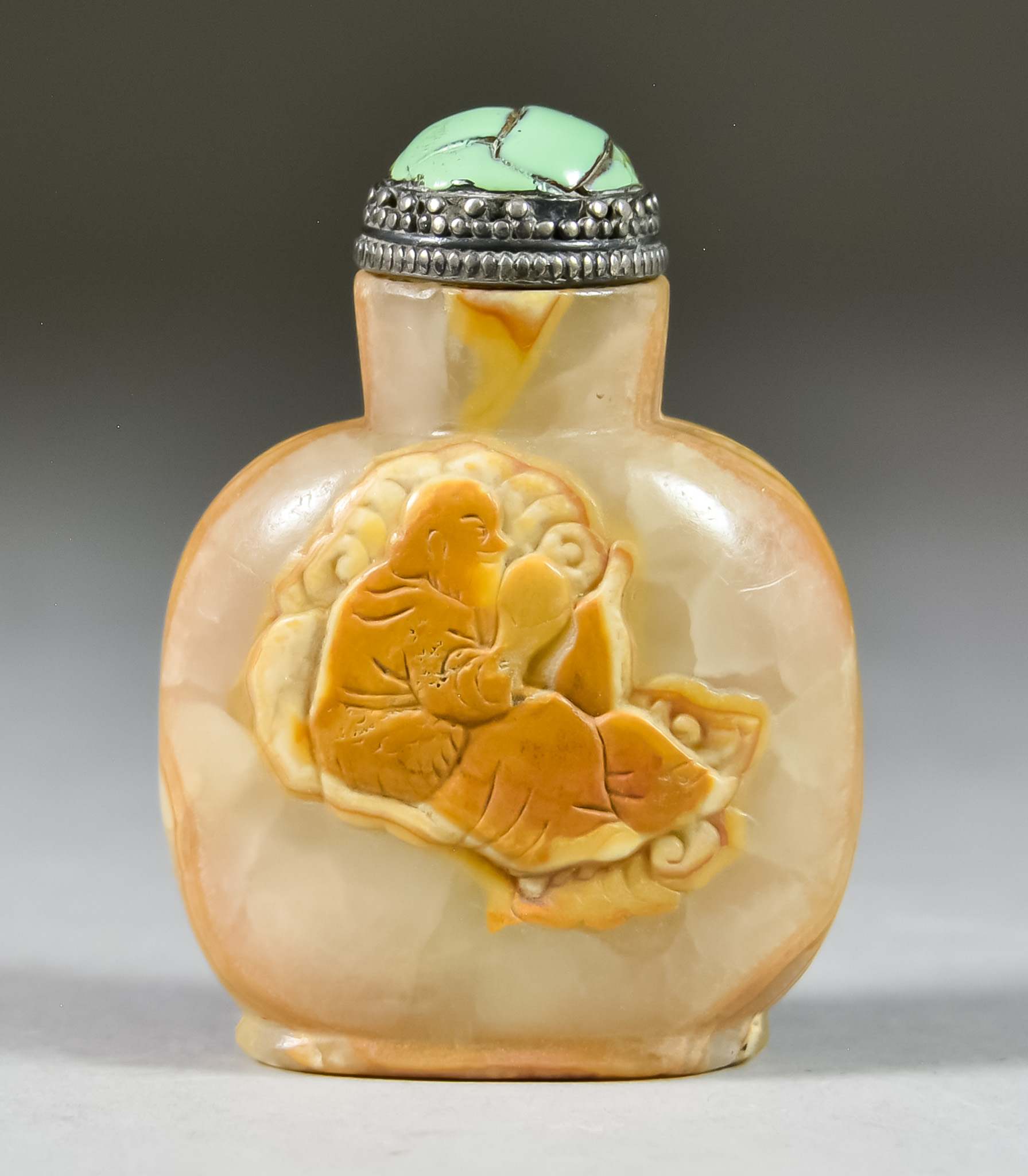 A Chinese Serpentine Snuff Bottle, Late 18th/First Half 19th Century, of flattened ovoid form, the