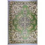 A 20th Century Indian Carpet of Kirman Design, woven in colours of green, ivory and fawn, the bold